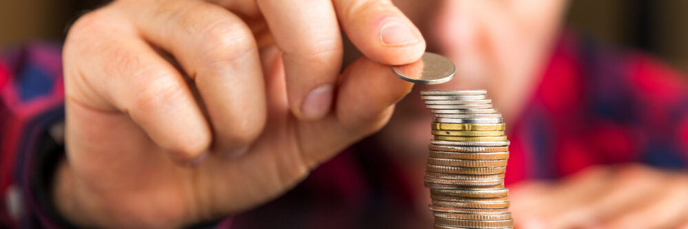 Man,Counts,His,Coins,On,A,Table.,Personal,Finance,,Finance