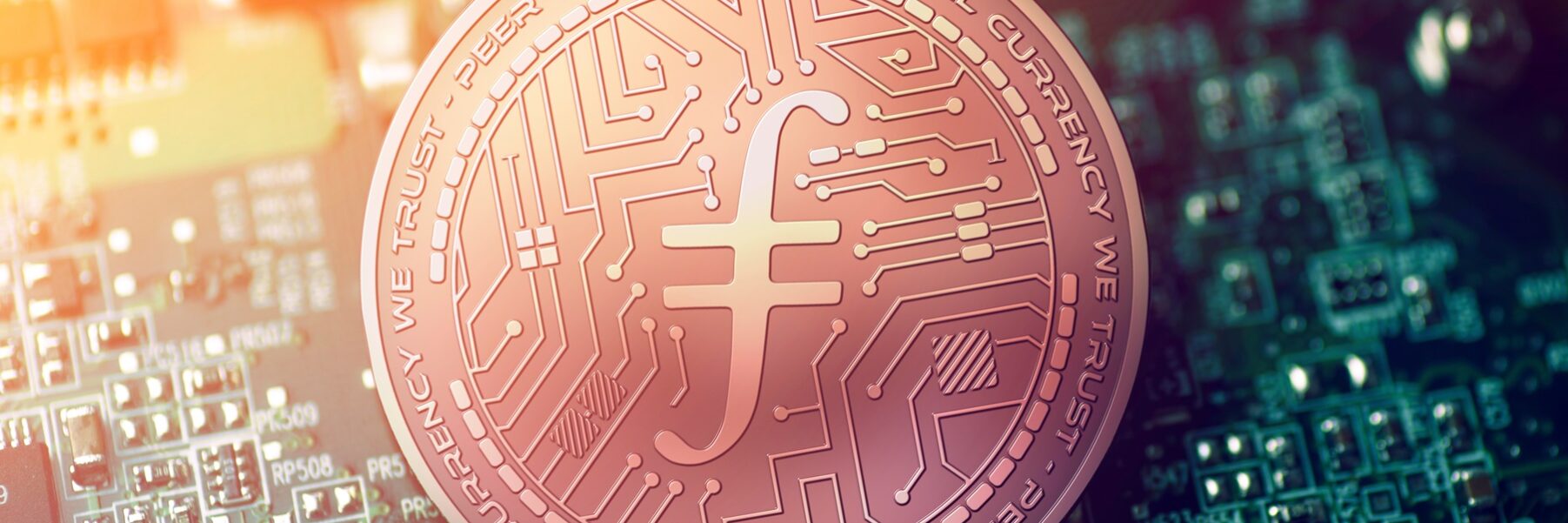 Shiny,Copper,Filecoin,Cryptocurrency,Coin,On,Blurry,Motherboard,Background