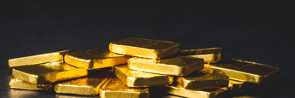 Stack,Of,Pure,Gold,Bars,On,Black,Background