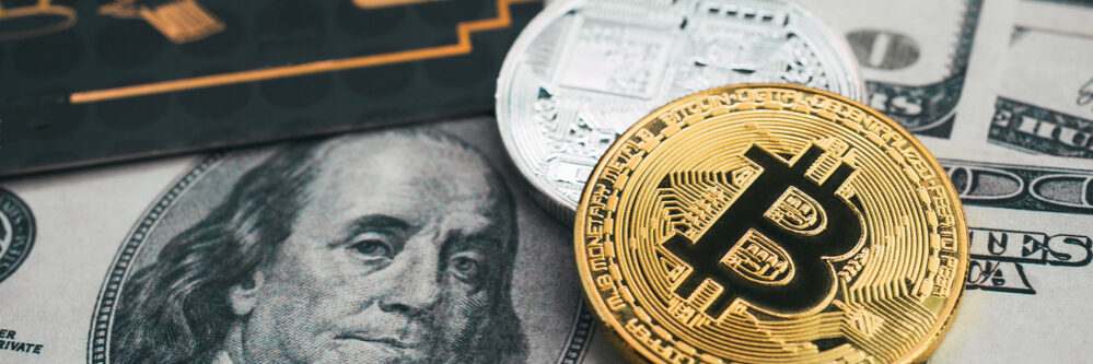 Golden,Bitcoin,With,Credit,Card,On,Top,Of,Dollar,Banknote