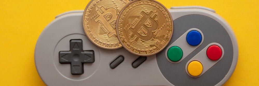 Crypto,Gaming,Concept.,Video,Game,Controller,With,A,Bitcoin,Cryptocurrency