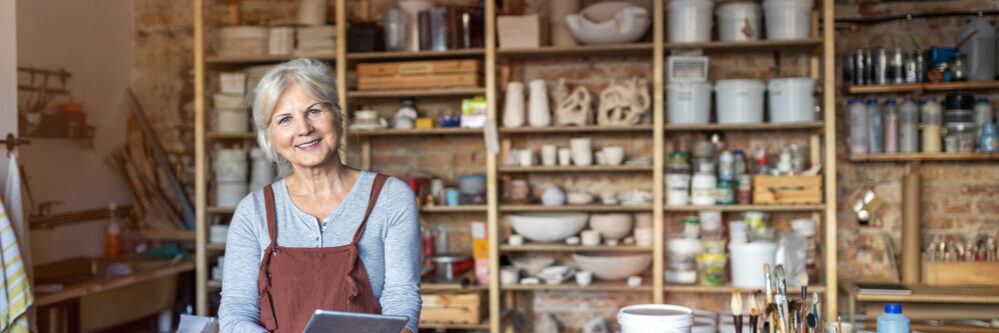 Senior,Craftswoman,With,Tablet,Computer,In,Art,Studio